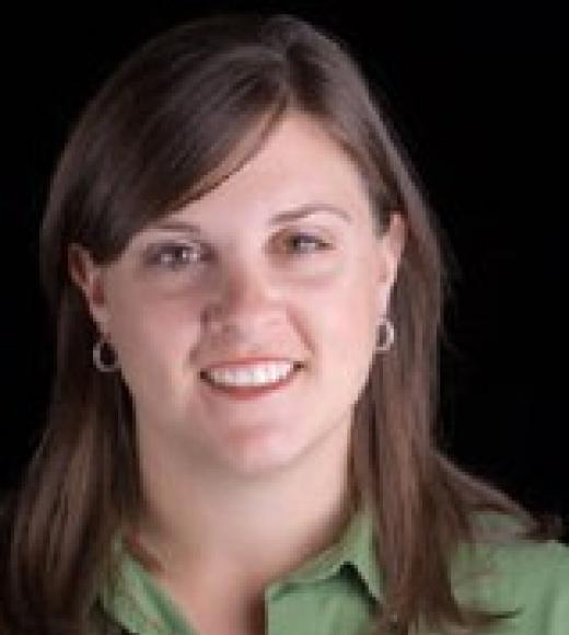 Photo of white woman, brown hair, and a green shirt